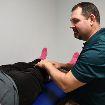 Therapist performing lymphedema therapy on patient's knee