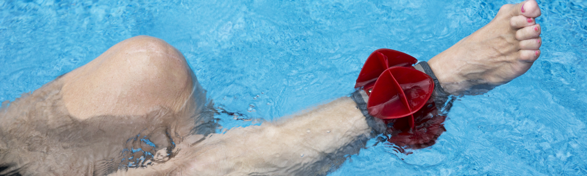 Person wearing a weight around ankle during aquatic therapy